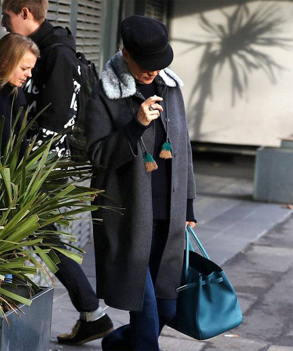 Kate Moss keeps a low profile in a baker boy hat and tasselled coat as she enjoys a pamper session at luxury spa in London